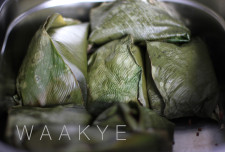 Waakye - rice and brown beans served in green leaves.