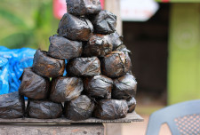 Kenke (A pounded, fermented maize meal staple. After soaking the maize meal in water, they are partially cooked and then steamed in banana leaves before being sold).